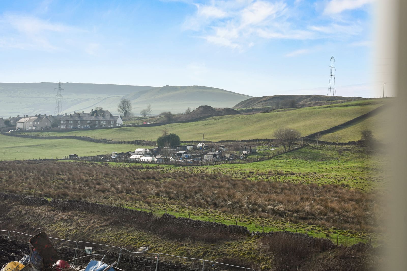 Rolling countryside with a village in the valley below