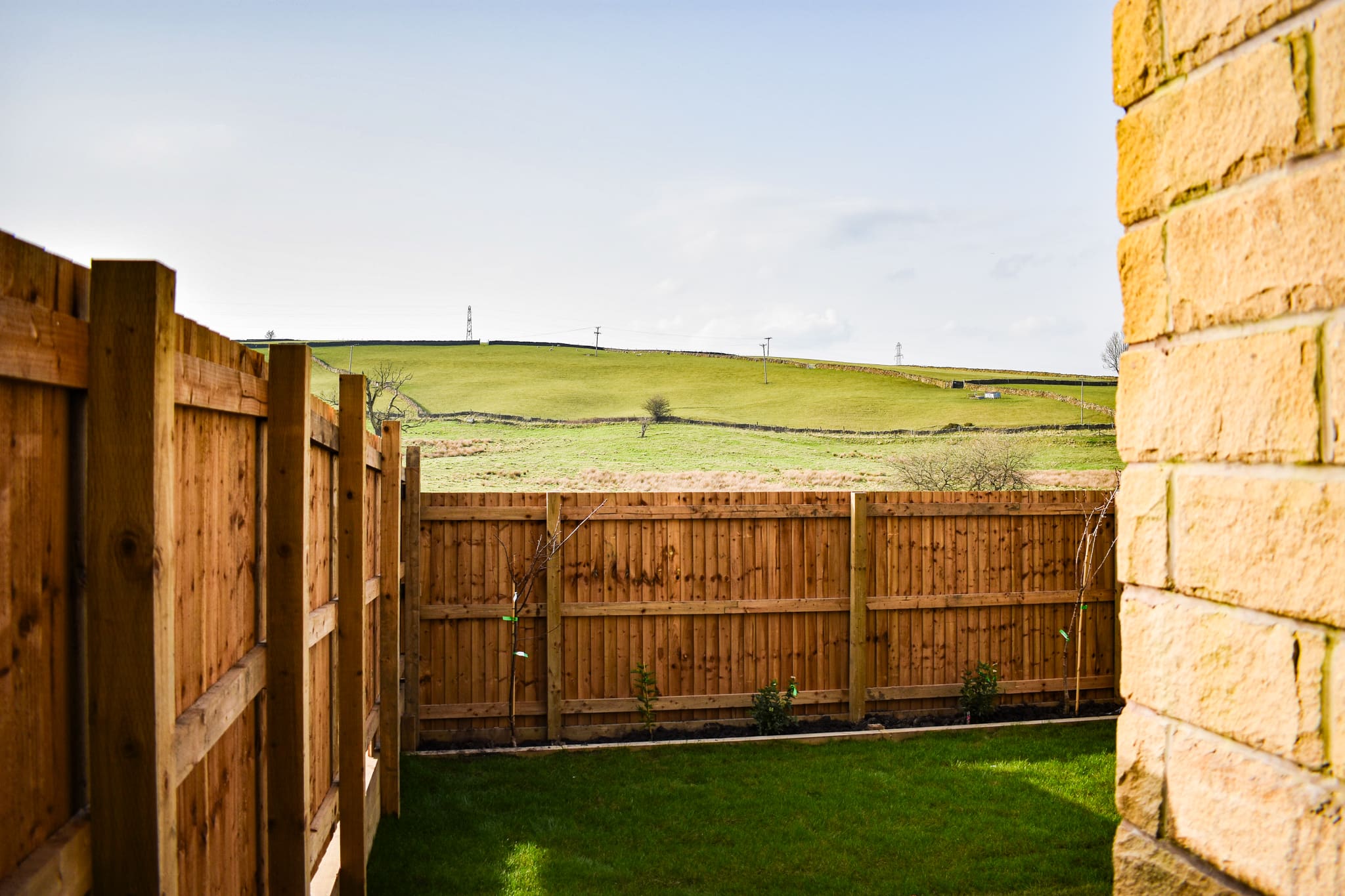 The view from a Hallstead Meadow back garden, over the fence to open High Peak hillside